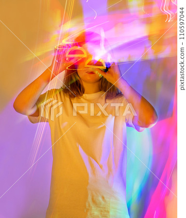 Figure wearing VR glasses experiencing a new virtual world. Figure wearing VR glasses experiencing a new virtual world. 110597044