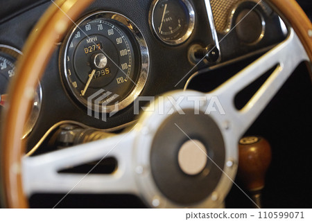 Steering wheel of vintage car at an antique car exhibition in Denmark 110599071