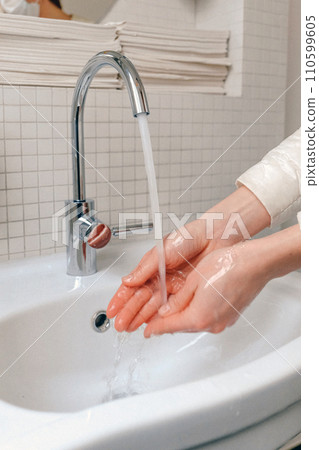 Hands wash procedure, cleaning hands with soap from viruses and contamination. Wash hands before dinner Hands wash procedure, cleaning hands with soap from viruses and contamination. Wash hands before dinner 110599605