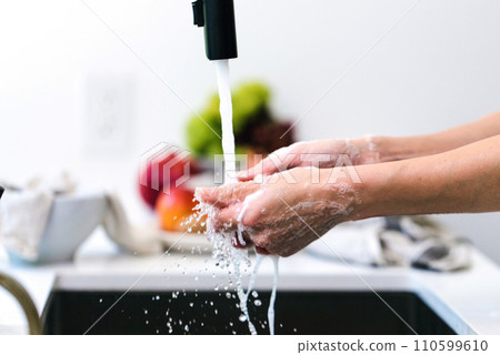 Hands wash procedure, cleaning hands with soap from viruses and contamination. Wash hands before dinner 110599610