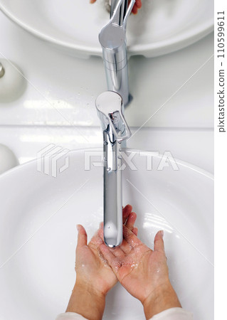 Hands wash procedure, cleaning hands with soap from viruses and contamination. Wash hands before dinner 110599611
