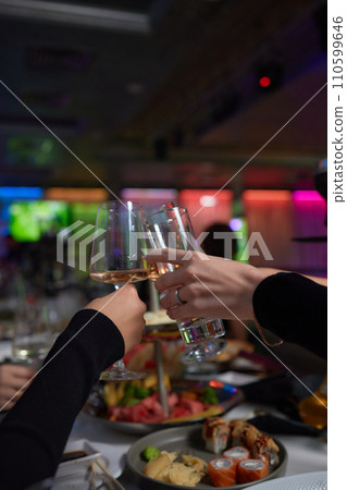 Clinking glasses with alcohol and toasting, party. 110599646