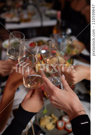 Clinking glasses with alcohol and toasting, party. 110599647
