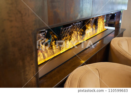 Electric log fireplace. Restaurant showcase decorated with artificial heater. Exterior design. 110599683