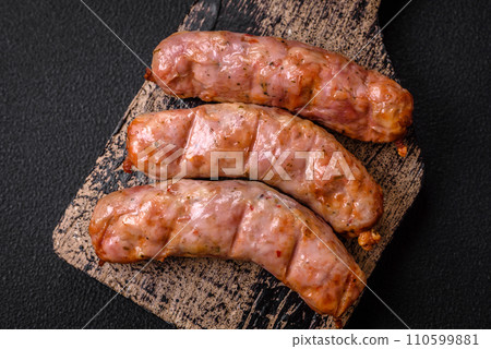 Delicious juicy grilled chicken or pork sausages with salt, spices and herbs 110599881