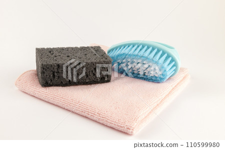 Clean sponge brush and rag. Cleaning rags on a white background. Tools for washing dishes. 110599980