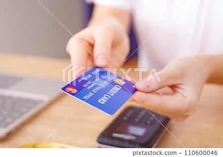 woman paying with credit card woman paying with credit card 110600046