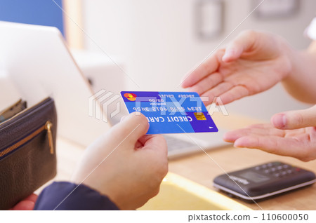 woman paying with credit card woman paying with credit card 110600050