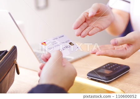 woman paying with credit card woman paying with credit card 110600052