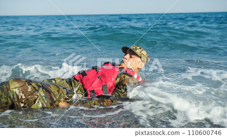 Military man with camouflage and life jacket as safety concept Military man with camouflage and life jacket as safety concept 110600746