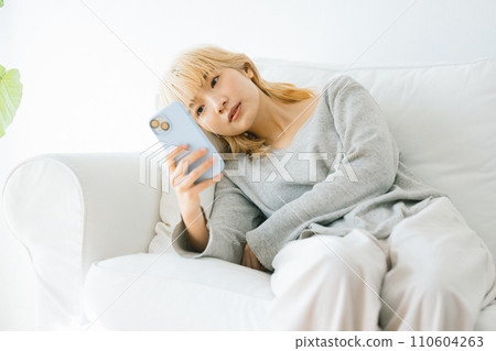 A woman looking at a smartphone A woman looking at a smartphone 110604263