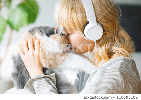young woman holding a cat 110605109