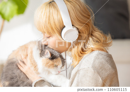 young woman holding a cat 110605115