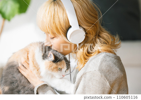 young woman holding a cat 110605116