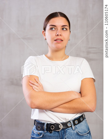 Thoughtful young woman standing in contemplative position Thoughtful young woman standing in contemplative position 110605174