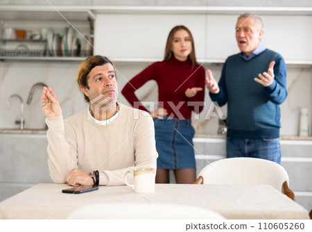 Man and girl quarrel with older man 110605260
