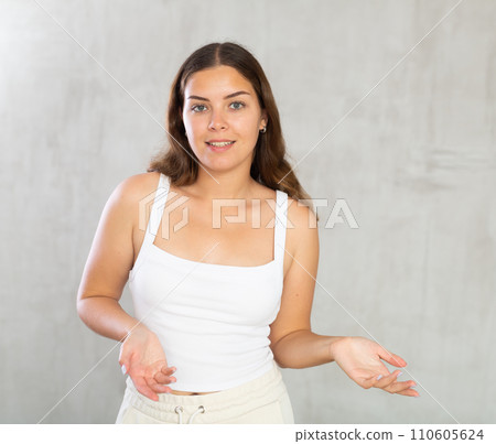 Young woman in casual clothes posing in studio 110605624