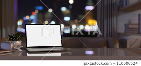 Modern apartment living room at night with a white-screen laptop computer and accessories on a table Modern apartment living room at night with a white-screen laptop computer and accessories on a table 110606524