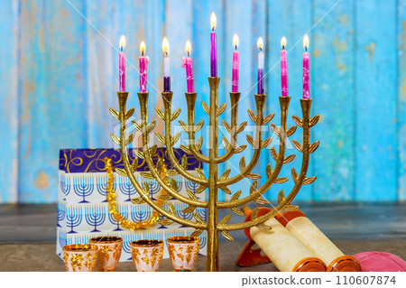 As symbol of Hanukkah in Jewish religion, Hanukkah Menorah is lit with candles As symbol of Hanukkah in Jewish religion, Hanukkah Menorah is lit with candles 110607874
