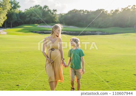 Heartwarming outdoor bonding as a pregnant mom and her son enjoy quality time together, savoring the beauty of nature and creating cherished moments Heartwarming outdoor bonding as a pregnant mom and her son enjoy quality time together, savoring the beauty of nature and creating cherished moments 110607944