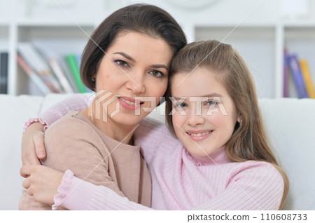 Close-up portrait of a charming girl with mom Close-up portrait of a charming girl with mom 110608733