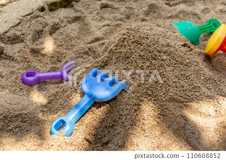 Sandpit and plastic playground equipment in the park Sandpit and plastic playground equipment in the park 110608852