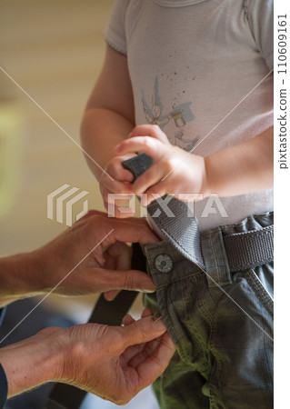 Caregiver Fastening Child's Belt 110609161