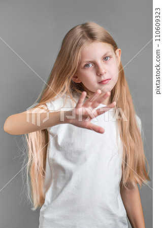 A little girl showing a sign of protest or refusal with her hand. 110609323
