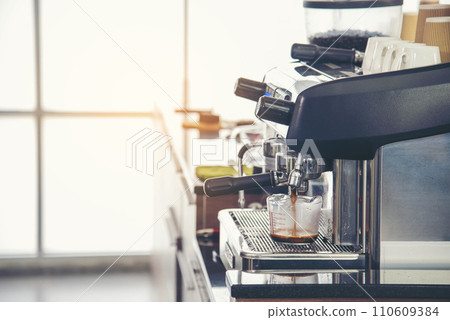 Close up hands coffee barista man make hot cup espresso shot from coffee machine. Cappuccino with milk in italian coffee shop cafe. Close up hands of barista use machine make black drinking hot cup Close up hands coffee barista man make hot cup espresso shot from coffee machine. Cappuccino with milk in italian coffee shop cafe. Close up hands of barista use machine make black drinking hot cup 110609384