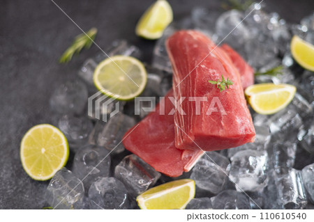 Fresh cooled tuna Fish steak lays on ice 110610540