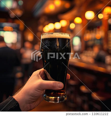Close-Up of Man Holding Beer Glass in Traditional Irish Pub with Warm Lighting Close-Up of Man Holding Beer Glass in Traditional Irish Pub with Warm Lighting 110611222