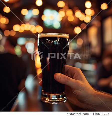 Close-Up of Man Holding Beer Glass in Traditional Irish Pub with Warm Lighting Close-Up of Man Holding Beer Glass in Traditional Irish Pub with Warm Lighting 110611223