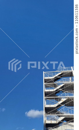 Building emergency stairs and clear blue sky Vertical Building emergency stairs and clear blue sky Vertical 110611386