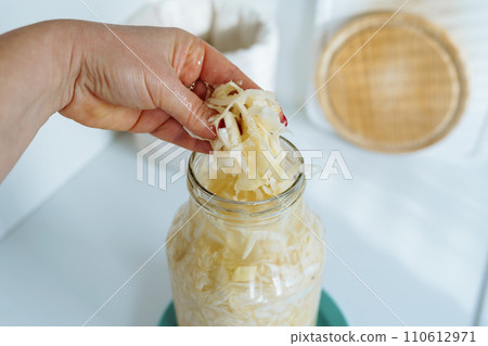 homemade sauerkraut in glass jar 110612971
