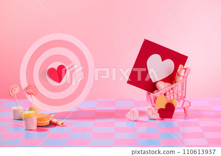 Creative background with blank space for design and advertising product on valentine day. Mini cute decorations, cakes and candy, bullseye and red paper card Creative background with blank space for design and advertising product on valentine day. Mini cute decorations, cakes and candy, bullseye and red paper card 110613937