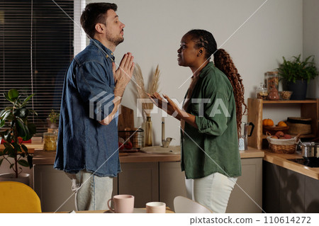 Man begging his wife to stop shouting Man begging his wife to stop shouting 110614272