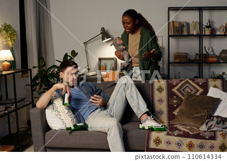 Woman shouting at drunk husband 110614334