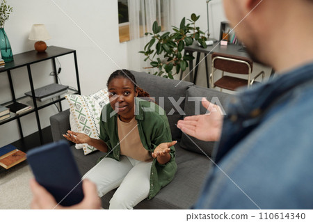 Young wife making excuses to husband 110614340