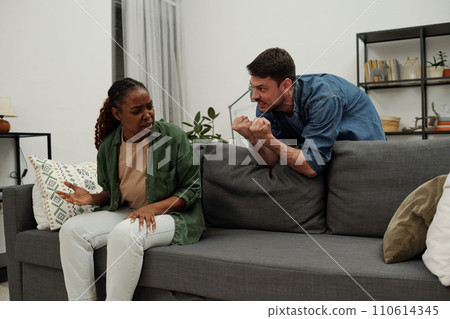 Furious man showing his punches to wife 110614345