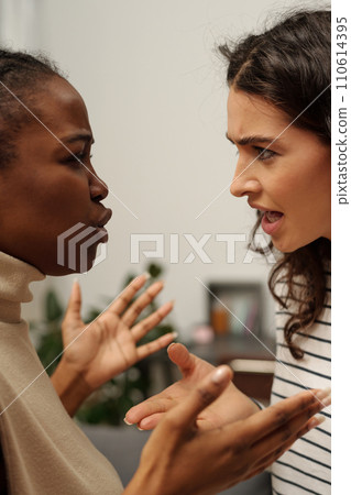 Two women screaming during conflict 110614395