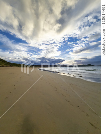 Beautiful cumulus clouds above Narin Strand, a beautiful large blue flag beach in Portnoo, County Donegal - Ireland. 110614491