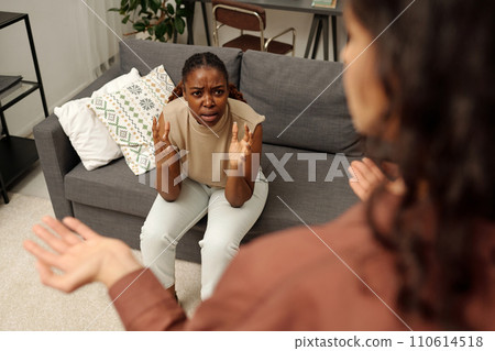 Woman looking at angry girlfriend Woman looking at angry girlfriend 110614518