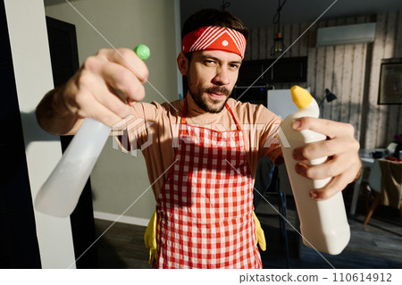 Young man in apron and headband 110614912