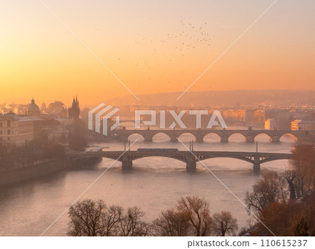 Prague bridge over a river with a city in the background 110615237