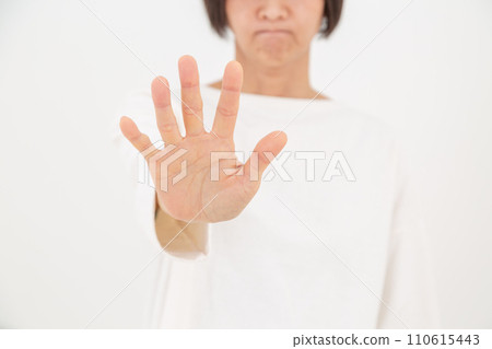 A middle-aged woman who refuses with her palms turned 110615443