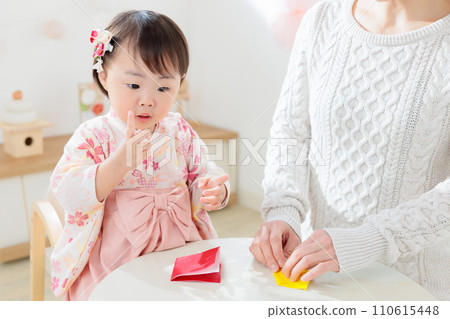 Parents and children fold origami to make New Year decorations 110615448
