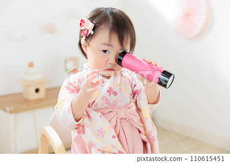Infant looking into a handmade kaleidoscope 110615451