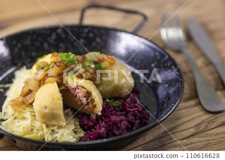 dumpllings filled with smoked meat served with red and white cabbage dumpllings filled with smoked meat served with red and white cabbage 110616628