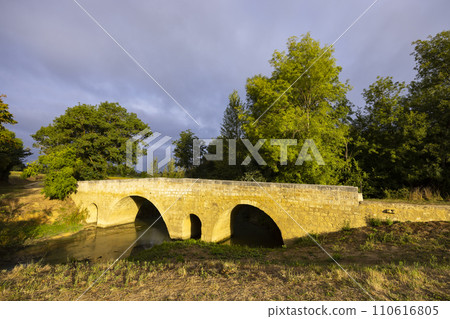 Romanesque bridge of Artigue and river Osse near Larressingle on route to Santiago de Compostela, UNESCO World Heritage Site, departement Gers, France 110616805