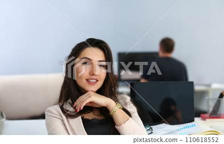 Portrait of smiling businesswoman at her working table 110618552